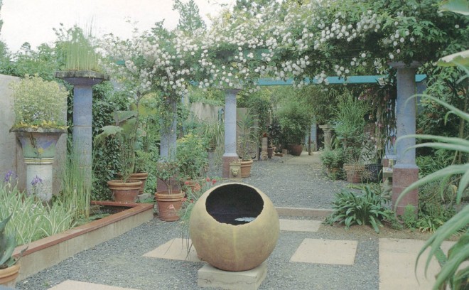 The entry court of Little and Lewis. The sphere in the foreground is thirty inches in diameter and faces south. The midday sun strikes the surface of the water inside, creating waves of light on the dark inner surface. Paul’s Himalayan rose clambers over the blue Doric Pergola in the background. Photographs by Little and Lewis