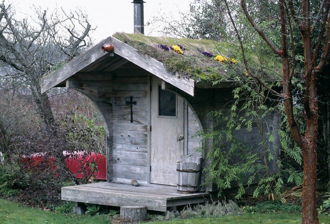 Anne built the cedar sauna house after enjoying one on a fishing trip to Alaska. She cut sod from the lawn and hefted it to the roof, planting crocuses and other tiny bulbs in the grass. As a result, the structure softly blends into the landscape.