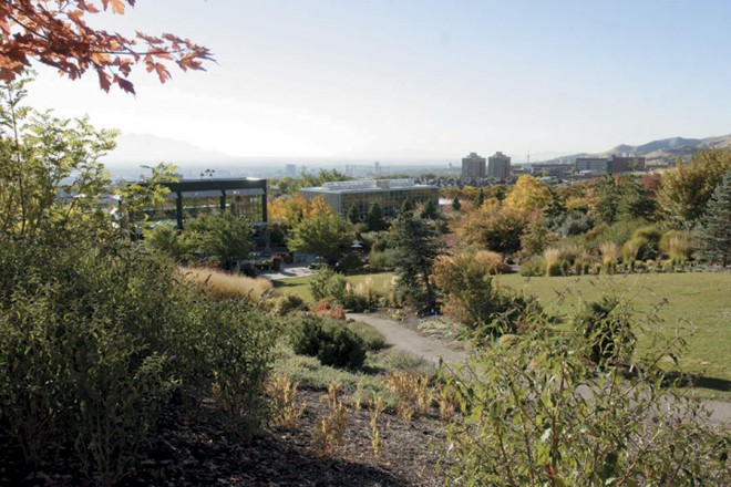 From a high point in the Four Seasons Garden, visitors can look back on the Visitor’s Center and the distant skyline of Salt Lake City