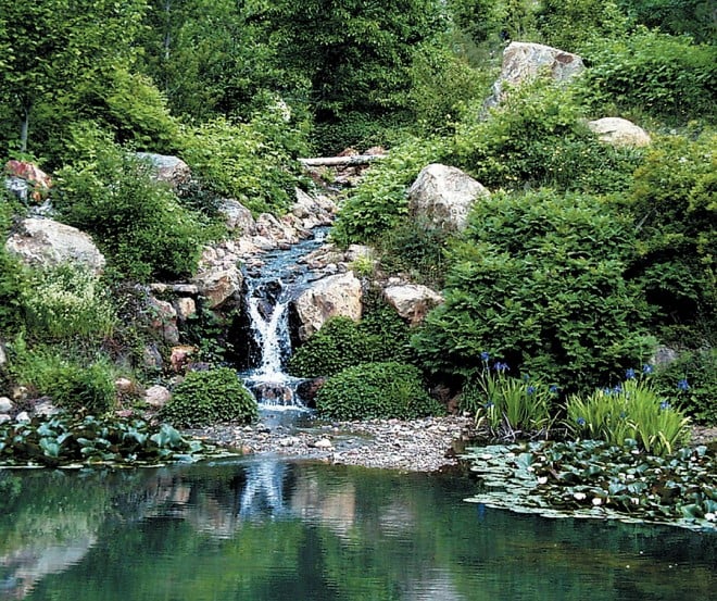 A stream and waterfall connect two of the ponds at Quarryhill.