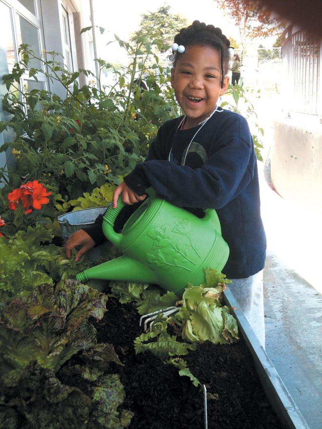 An enthusiastic young gardener at the Seattle Children’s PlayGarden