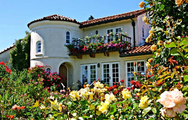 The charming mediterranean-style home at the Russian River Rose Company bedecked with blooms. Photo: Mikala Kennan