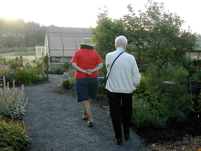 Brewster Rogerson and Linda Beutler strolling in the Rogerson Clematis Collection. Photo: Larry Beutler