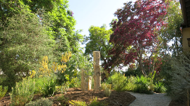 standing stones in the completed front garden are reclaimed kansas fence posts pieces of ancient