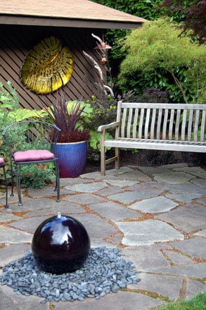 The garden is furnished with artwork and accessories that complement the plantings. Photo: Deb Caulderon