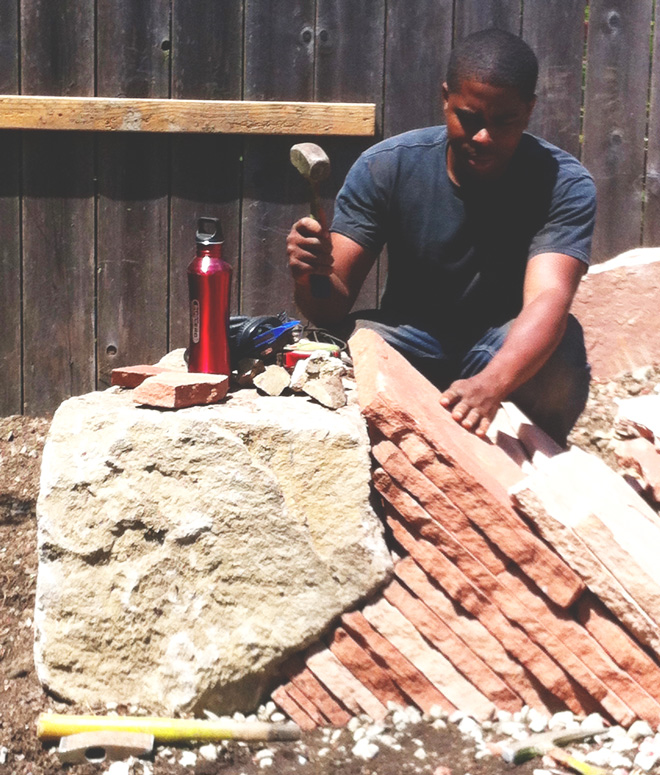 Charles skillfully installs a section of detailed stonework, a Mariposa Gardening & Design hardscape signature. Photo: Andrea Hurd